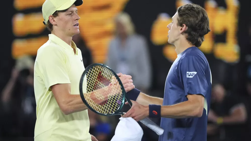 Jannik Sinner, left, of Italy is congratulated by Alex de Minaur of Australia following their quarterfinal match at the Australian Open tennis championship in Melbourne, Australia, Wednesday, Jan. 22, 2025. (AP Photo/Vincent Thian)