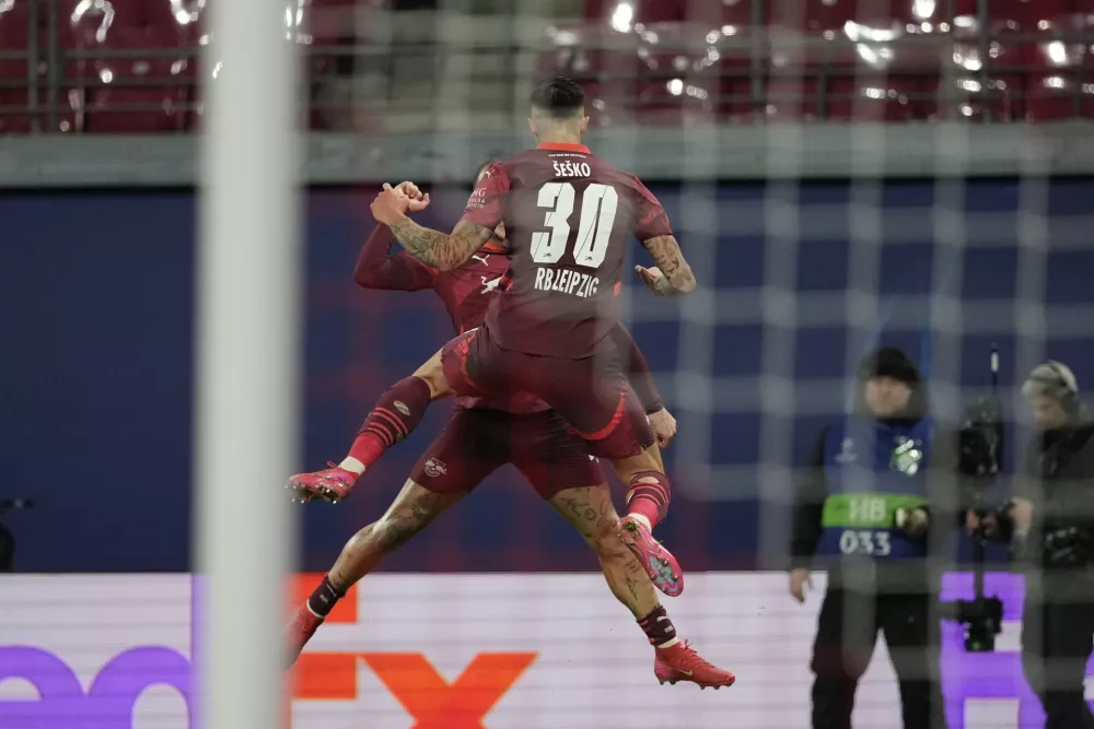 Leipzig's Benjamin Sesko celebrates after scoring his side's opening goal during the Champions League soccer match between RB Leipzig and Sporting CP at the RB Arena in Leipzig, Germany, Wednesday, Jan. 22, 2025. (AP Photo/Matthias Schrader)