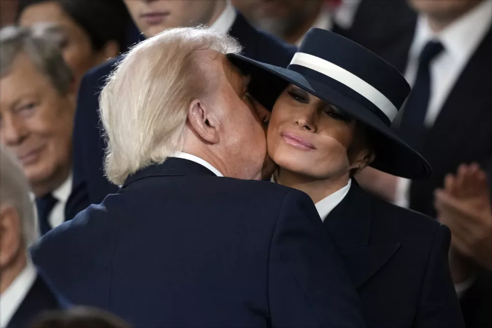 President Donald Trump kisses first lady Melania Trump during the 60th Presidential Inauguration in the Rotunda of the U.S. Capitol in Washington, Monday, Jan. 20, 2025. (AP Photo/Julia Demaree Nikhinson, Pool)