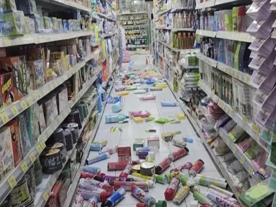 In this image from a video, bottles and cans are scattered on the floor at a convenience store in Tainan, Taiwan Tuesday, Jan. 21, 2025 after an earthquake. (TVBS via AP)