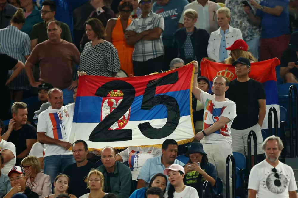 Tennis - Australian Open - Melbourne Park, Melbourne, Australia - January 22, 2025 Fans of Serbia's Novak Djokovic hold up a banner in the stands during his quarter final match against Spain's Carlos Alcaraz REUTERS/Edgar Su