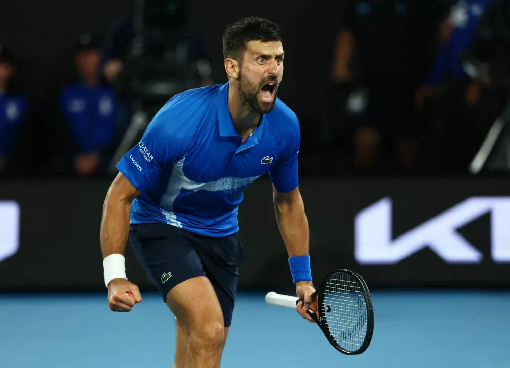 Tennis - Australian Open - Melbourne Park, Melbourne, Australia - January 22, 2025 Serbia's Novak Djokovic celebrates after winning his quarter final match against Spain's Carlos Alcaraz REUTERS/Edgar Su