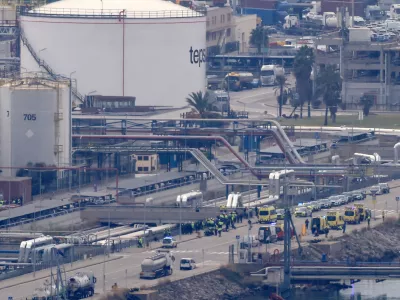 Police officers and emergency services workers respond after a blast during maintenance work at the so-called "Energy Wharf", where chemicals, natural gas and refined petroleum products are loaded, in the port of Barcelona, Spain January 21, 2025. REUTERS/Nacho Doce