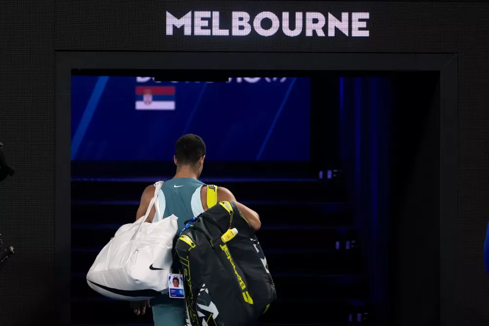 Carlos Alcaraz of Spain walks from Rod Laver Arena following his quarterfinal loss to Novak Djokovic of Serbia at the Australian Open tennis championship in Melbourne, Australia, early Wednesday, Jan. 22, 2025. (AP Photo/Asanka Brendon Ratnayake)