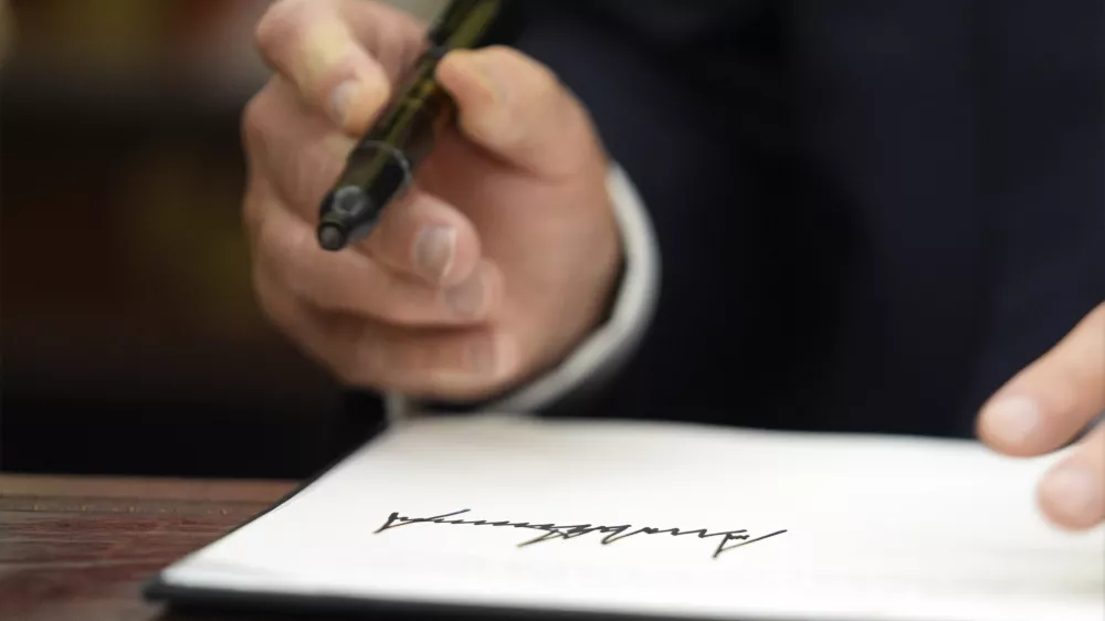 President Donald Trump signs executive orders in the Oval Office of the White House, Monday, Jan. 20, 2025, in Washington. (AP Photo/Evan Vucci)