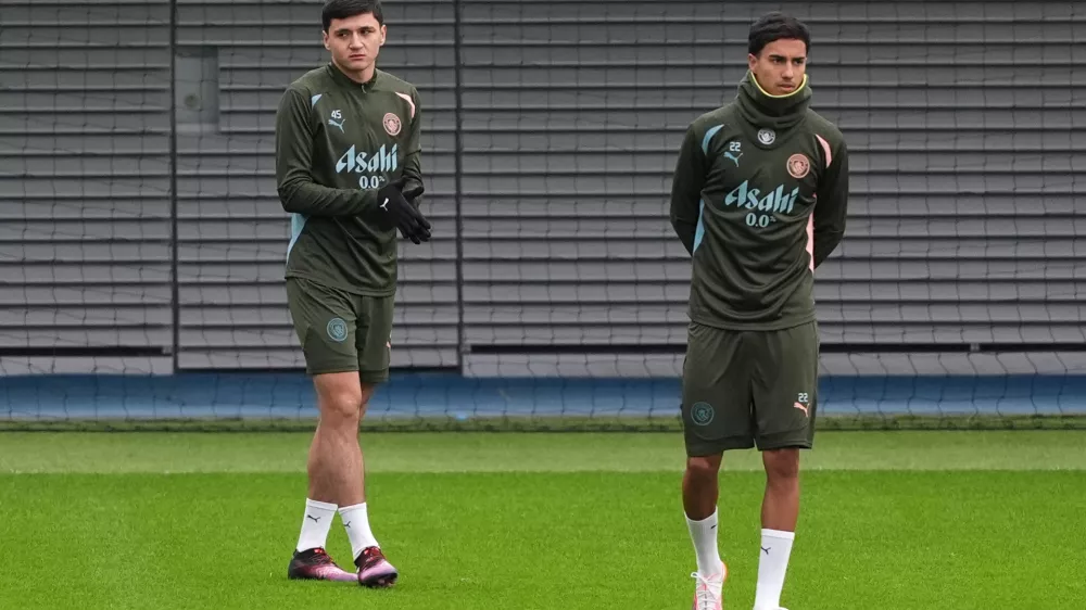 21 January 2025, United Kingdom, Manchester: Manchester City's Abdukodir Khusanov (L) and Vitor Reis in action during a training session at the City Football Academy. Photo: Martin Rickett/PA Wire/dpa