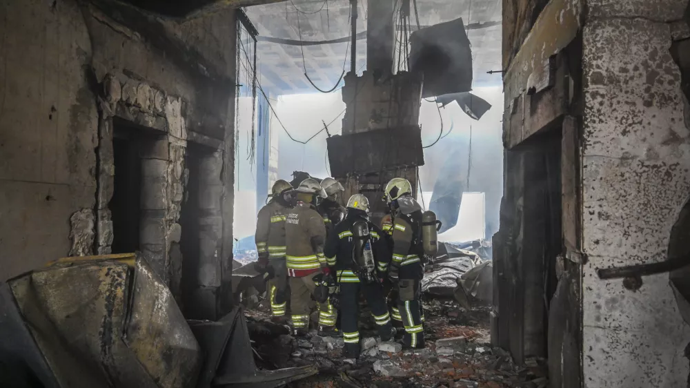 Firefighters work at the scene after a fire broke out at a hotel in the ski resort of Kartalkaya, located in the Bolu province, northwest Turkey, Tuesday, Jan. 21, 2025. (Mert Gokhan Koc/dia Photo via AP)