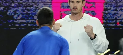 Andy Murray reacts with Novak Djokovic following his win over Carlos Alcaraz of Spain in their quarterfinal match at the Australian Open tennis championship in Melbourne, Australia, early Wednesday, Jan. 22, 2025. (AP Photo/Vincent Thian)