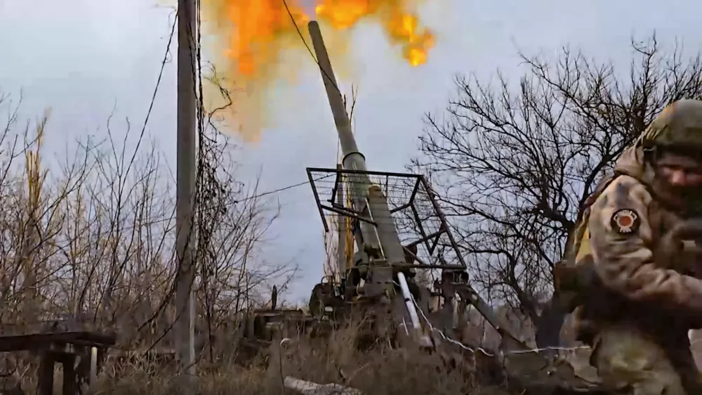 In this photo taken from video distributed by Russian Defense Ministry Press Service on Wednesday, Jan. 22, 2025, a Russian soldier fires a self-propelled gun "Malka" toward Ukrainian positions in an undisclosed location in Ukraine. (Russian Defense Ministry Press Service via AP)