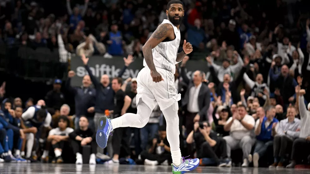 Jan 22, 2025; Dallas, Texas, USA; Dallas Mavericks guard Kyrie Irving (11) runs back up the court after making a three point shot against the Minnesota Timberwolves during the second half at the American Airlines Center. Mandatory Credit: Jerome Miron-Imagn Images