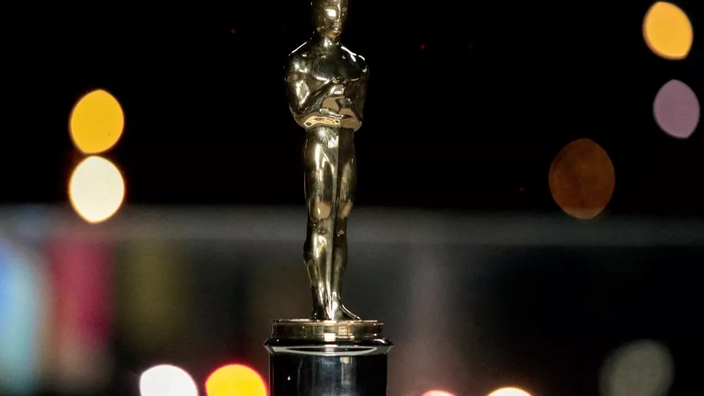 FILE PHOTO: An Oscars statuette on display at a screening of the Oscars in Paris, France April 26, 2021. Lewis Joly/Pool via REUTERS/File Photo