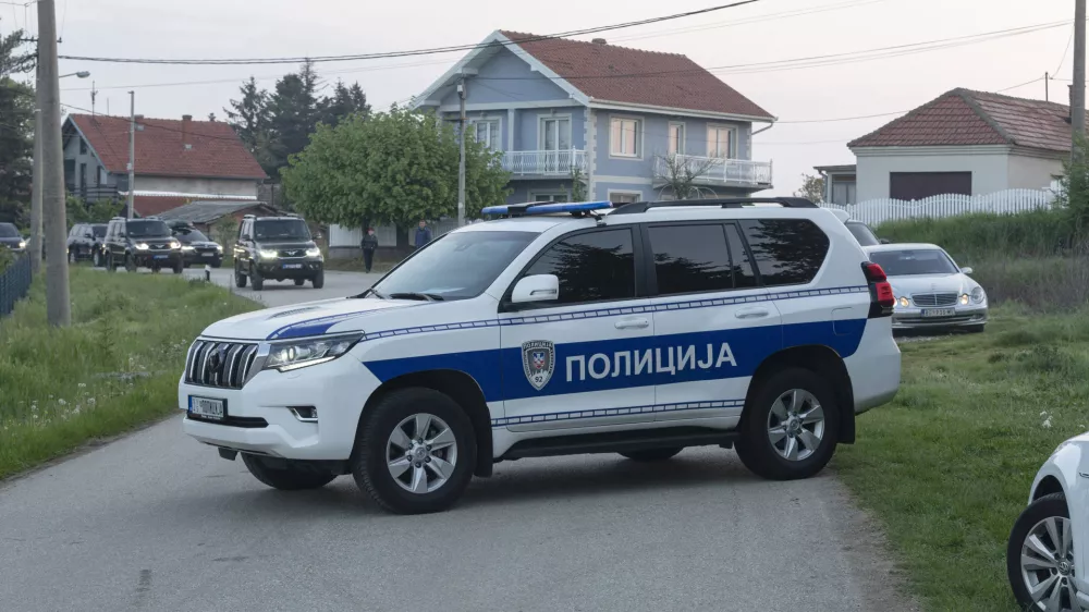 A police vehicle blocks the entrance to the village of Dubona, some 40 kilometers south of Belgrade, Serbia, Friday, May 5, 2023. A shooter killed multiple people and wounded more in a drive-by attack late Thursday in Serbia's second such mass killing in two days, state television reported. (AP Photo/Marko Drobnjakovic)