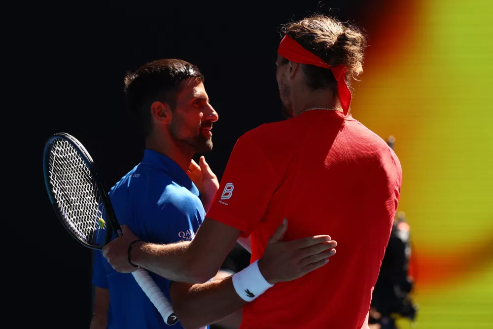 Tennis - Australian Open - Melbourne Park, Melbourne, Australia - January 24, 2025 Serbia's Novak Djokovic hugs Germany's Alexander Zverev after retiring from their semi final match REUTERS/Edgar Su