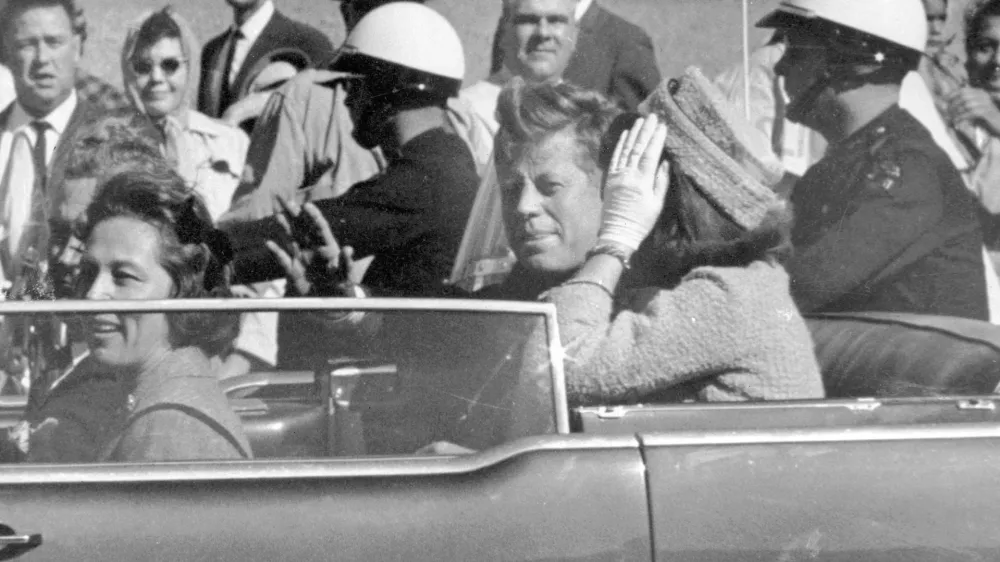 FILE - President John F. Kennedy waves from his car in a motorcade in Dallas, with first lady Jacqueline Kennedy, right, Nellie Connally, second from left, and her husband, Texas Gov. John Connally, far left, Nov. 22, 1963. (AP Photo/Jim Altgens, File)