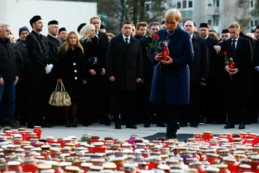 Slovenia's President Natasa Pirc Musar pays respects in front of the statue of a miner, as she mourns for the miners who died in the Velenje coal mine, in Velenje, Slovenia January 24, 2025. REUTERS/Borut Zivulovic