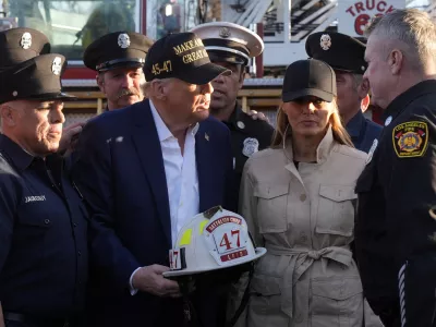 President Donald Trump and first lady Melania Trump talk with Los Angeles firefighters as they tour the Pacific Palisades neighborhood affected by recent wildfires in Los Angeles, Friday, Jan. 24, 2025. (AP Photo/Mark Schiefelbein)