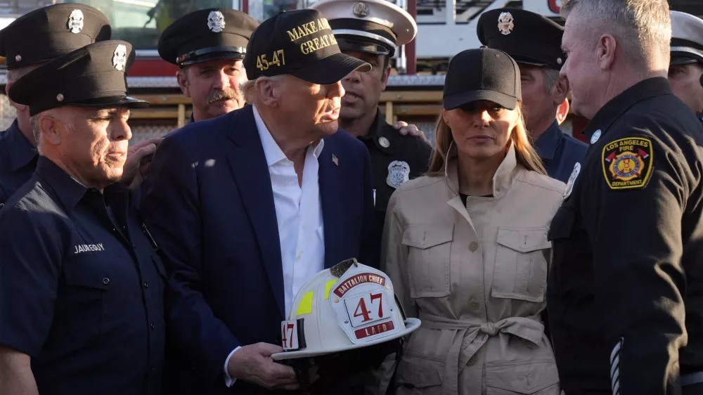 President Donald Trump and first lady Melania Trump talk with Los Angeles firefighters as they tour the Pacific Palisades neighborhood affected by recent wildfires in Los Angeles, Friday, Jan. 24, 2025. (AP Photo/Mark Schiefelbein)