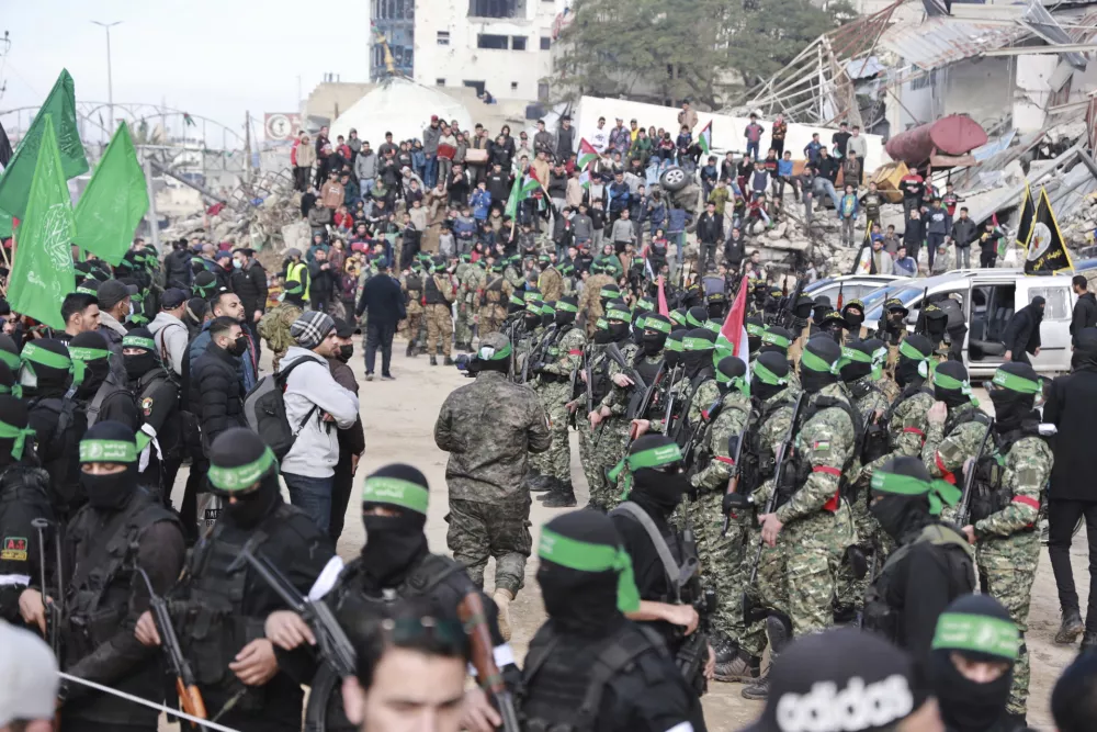 Hamas fighters are deployed in central Gaza City ahead of the planned release of four Israeli female hostages set to be handed over to the Red Cross in Gaza City on Saturday, Jan. 25, 2025. (AP Photo/Abed Hajjar)