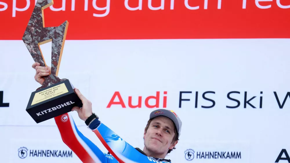 Alpine Skiing - FIS Alpine Ski World Cup - Men's Slalom - Kitzbuehel, Austria - January 26, 2025 France's Clement Noel celebrates with the trophy on the podium after winning the Men's Slalom REUTERS/Lisi Niesner