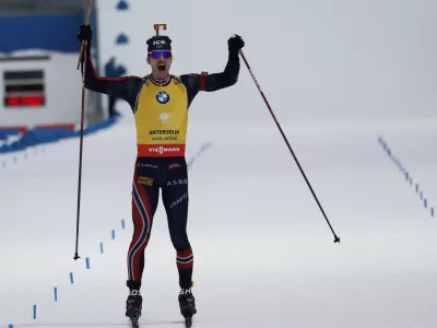 Norway's Sturla Holm Laegreid celebrates as he wins a Biathlon men's World Cup 12.5 km pursuit race, in Anterselva, Italy, Sunday, Jan. 26, 2025. (AP Photo/Alessandro Trovati)