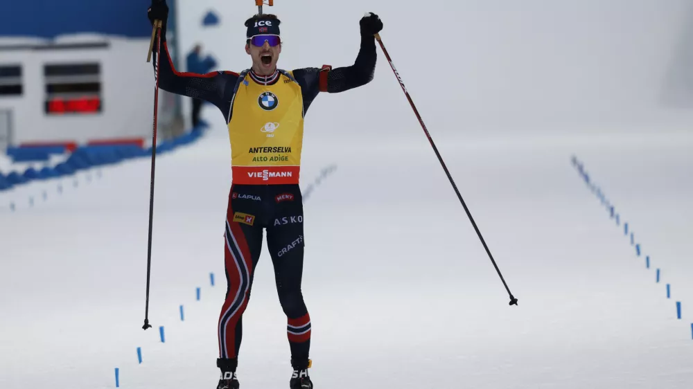 Norway's Sturla Holm Laegreid celebrates as he wins a Biathlon men's World Cup 12.5 km pursuit race, in Anterselva, Italy, Sunday, Jan. 26, 2025. (AP Photo/Alessandro Trovati)