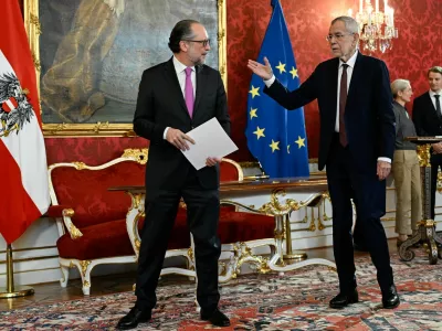 Austria's President Alexander Van der Bellen gestures next to designated Chancellor of the People's Party (OVP) Alexander Schallenberg at the swearing-in ceremony at Hofburg Palace in Vienna, Austria, January 10, 2025. REUTERS/Elisabeth Mandl