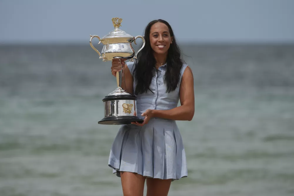 Madison Keys of the U.S. holds the Daphne Akhurst Memorial Cup at Brighton Beach the morning after defeating Aryna Sabalenka of Belarus in the women's singles final at the Australian Open tennis championship in Melbourne, Australia, Sunday, Jan. 26, 2025. (AP Photo/Vincent Thian)