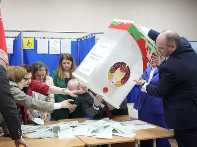 Election commission members prepare to count ballots after voting for the presidential election at a polling station in Minsk, Belarus, Sunday, Jan. 26, 2025. (AP Photo/Pavel Bednyakov)