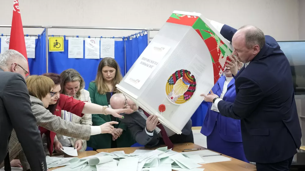 Election commission members prepare to count ballots after voting for the presidential election at a polling station in Minsk, Belarus, Sunday, Jan. 26, 2025. (AP Photo/Pavel Bednyakov)