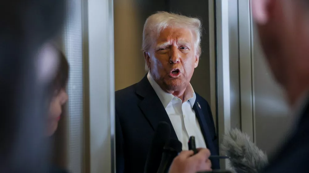 U.S. President Donald Trump speaks with reporters as they ask questions aboard Air Force One during a flight from Las Vegas, Nevada, to Miami, Florida, U.S., January 25, 2025. REUTERS/Leah Millis