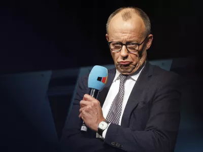 Federal Chairman of the CDU and candidate for Chancellor of the Union, Friedrich Merz speaks at a campaign event for the 2025 Bundestag election campaign, at the Neuhof community center, in Neuhof, Germany, Saturday, Jan. 25, 2025. (Lando Hass/dpa via AP)