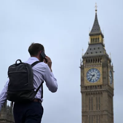 FILE PHOTO: A man walks with his phone on Westminster Bridge towards Big Ben in Westminster, London, Britain, September 2, 2024. REUTERS/Jaimi Joy/File Photo