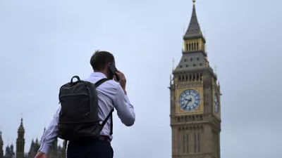 FILE PHOTO: A man walks with his phone on Westminster Bridge towards Big Ben in Westminster, London, Britain, September 2, 2024. REUTERS/Jaimi Joy/File Photo