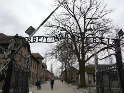 People visit the Memorial and Museum Auschwitz-Birkenau, a former Nazi German concentration and extermination camp, in Oswiecim, Poland, Sunday, Jan. 26, 2025. (AP Photo/Czarek Sokolowski)