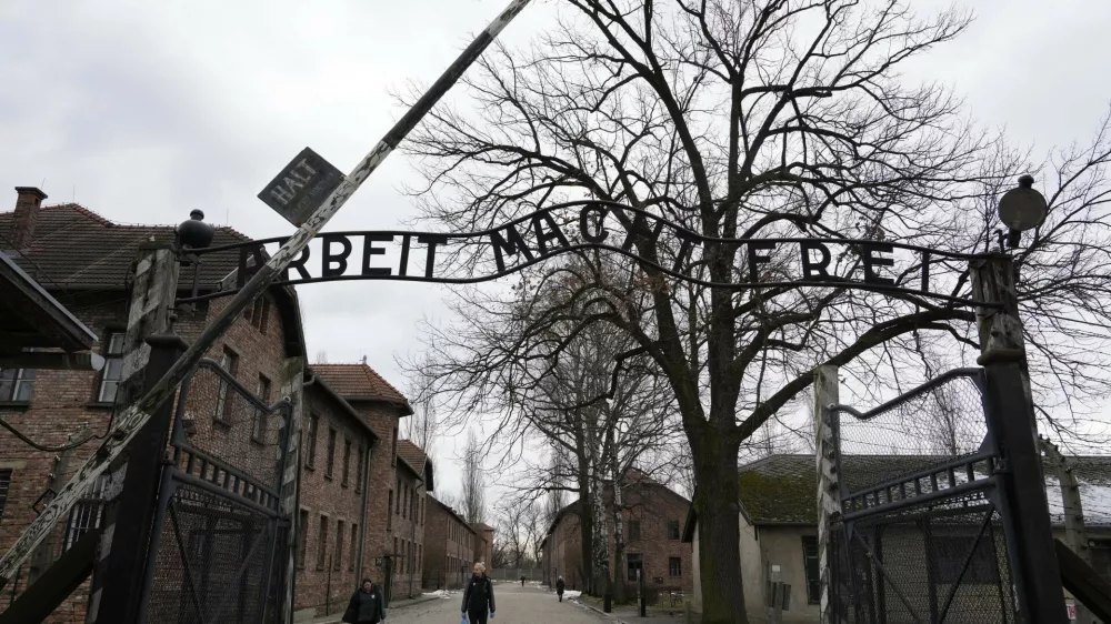 People visit the Memorial and Museum Auschwitz-Birkenau, a former Nazi German concentration and extermination camp, in Oswiecim, Poland, Sunday, Jan. 26, 2025. (AP Photo/Czarek Sokolowski)