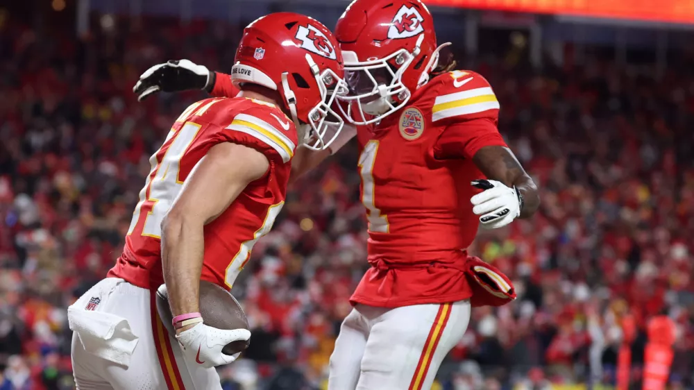 Jan 26, 2025; Kansas City, MO, USA; Kansas City Chiefs wide receiver Justin Watson (84) reacts with wide receiver Xavier Worthy (1) after making a catch for a two point conversion against the Buffalo Bills during the second half in the AFC Championship game at GEHA Field at Arrowhead Stadium. Mandatory Credit: Mark J. Rebilas-Imagn Images