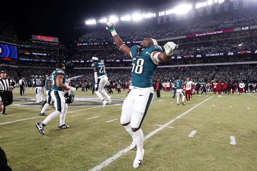 Jan 26, 2025; Philadelphia, PA, USA; Philadelphia Eagles linebacker Jalyx Hunt (58) runs onto the field with teammates in celebration of winning the NFC Championship game against the Washington Commanders at Lincoln Financial Field. Mandatory Credit: Bill Streicher-Imagn Images