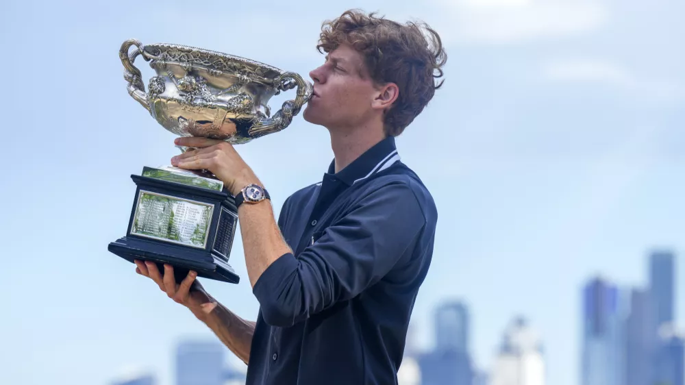 Jannik Sinner of Italy kisses Norman Brookes Challenge Cup the morning after defeating Alexander Zverev of Germany in the men's singles final at the Australian Open tennis championship in Melbourne, Australia, Monday, Jan. 27, 2025. (AP Photo/Mark Baker)