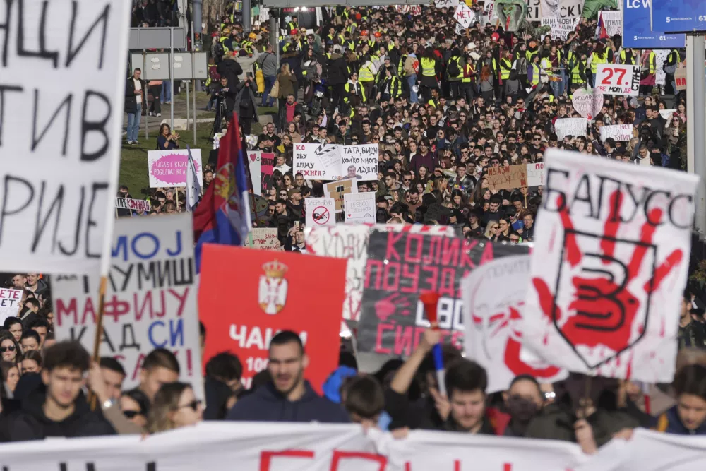 Students march during a student-led 24 hour block on an intersection to protest the deaths of 15 people killed in the November collapse of a train station canopy, in Belgrade, Serbia, Monday, Jan. 27, 2025. (AP Photo/Darko Vojinovic)