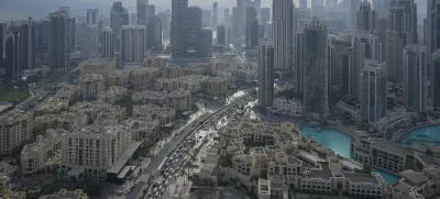 Vehicles ply at a slow pace through a street with Dubai's iconic skyline in the background, United Arab Emirates, on Dec. 31, 2024. (AP Photo/Altaf Qadri)