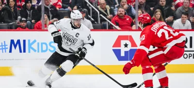 Jan 27, 2025; Detroit, Michigan, USA; Los Angeles Kings center Anze Kopitar (11) brings the puck up ice against Detroit Red Wings defenseman Albert Johansson (20) during the first period at Little Caesars Arena. Mandatory Credit: Tim Fuller-Imagn Images