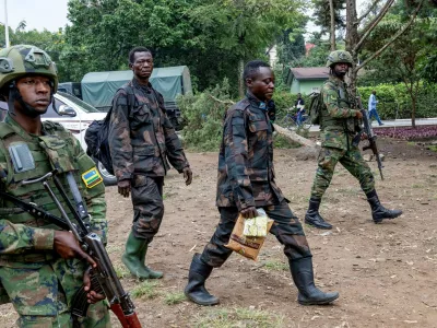 Rwandan security officers escort members of the Armed Forces of the Democratic Republic of the Congo (FARDC), who surrendered in Goma, eastern Democratic Republic of Congo following fighting between M23 rebels and the FARDC, in Gisenyi, Rwanda, January 27, 2025. REUTERS/Jean Bizimana