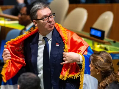 Serbian President Aleksandar Vucic wears Serbia's flag after voting in the United Nations General Assembly on the creation of an international day to commemorate the Srebrenica genocide, at the UN Headquarters in New York City, U.S. May 23, 2024. REUTERS/Eduardo Munoz