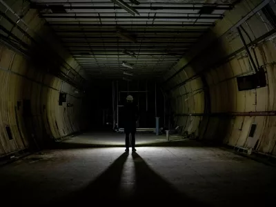 A journalist stands, as members of the press are shown around underground tunnels used during World War Two as shelters during the Blitz that are now due to be developed into a new tourist attraction called The London Tunnels, in London, Britain, January 29, 2025. REUTERS/Chris J. Ratcliffe  TPX IMAGES OF THE DAY