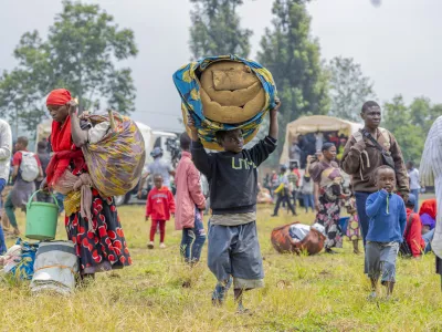 People who crossed from Congo wait for assistance in Gyseny, Rwanda, Tuesday, Jan. 28, 2025, following M23 rebels' advances into eastern Congo's capital Goma. (AP Photo/Yuhi Irakiza)