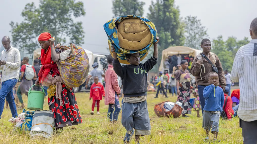 People who crossed from Congo wait for assistance in Gyseny, Rwanda, Tuesday, Jan. 28, 2025, following M23 rebels' advances into eastern Congo's capital Goma. (AP Photo/Yuhi Irakiza)