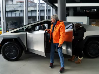 A person gets out of a Tesla Cybertruck at a Tesla showroom in New York City, U.S., January 2, 2025. REUTERS/Adam Gray