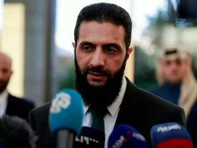 FILE PHOTO: Syria's de facto leader Ahmed al-Sharaa, also known as Abu Mohammed al-Golani, speaks to the media during a meeting with Qatar's Minister of State Mohammed bin Abdulaziz Al-Khulaifi, after the ousting of Syria's Bashar al-Assad, in Damascus, Syria, December 23, 2024. REUTERS/Ammar Awad/File Photo