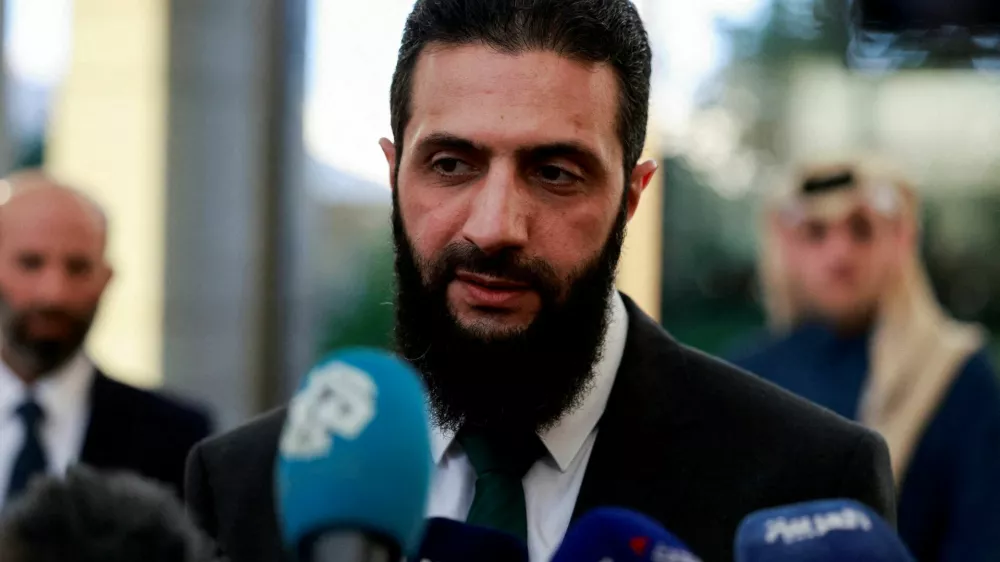 FILE PHOTO: Syria's de facto leader Ahmed al-Sharaa, also known as Abu Mohammed al-Golani, speaks to the media during a meeting with Qatar's Minister of State Mohammed bin Abdulaziz Al-Khulaifi, after the ousting of Syria's Bashar al-Assad, in Damascus, Syria, December 23, 2024. REUTERS/Ammar Awad/File Photo