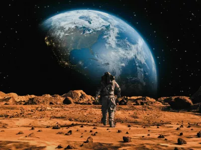 Following Shot of Brave Astronaut in Space Suit Confidently Walking on Mars Towards Earth Planet. Earth Planet as viewed from Mars surface. The surface of Mars, strewn with small rocks and red sand. Martian landscape in rusty orange shades, Mars Planet surface, Desert, Cliffs, sand. Red planet mars. Alien Red Planet Covered in Rocks. First Astronaut On the Mars. Big Moment for the Human Race. Advanced Technologies, Space Exploration/ Travel, Colonization Concept. / Foto: Nzoka John